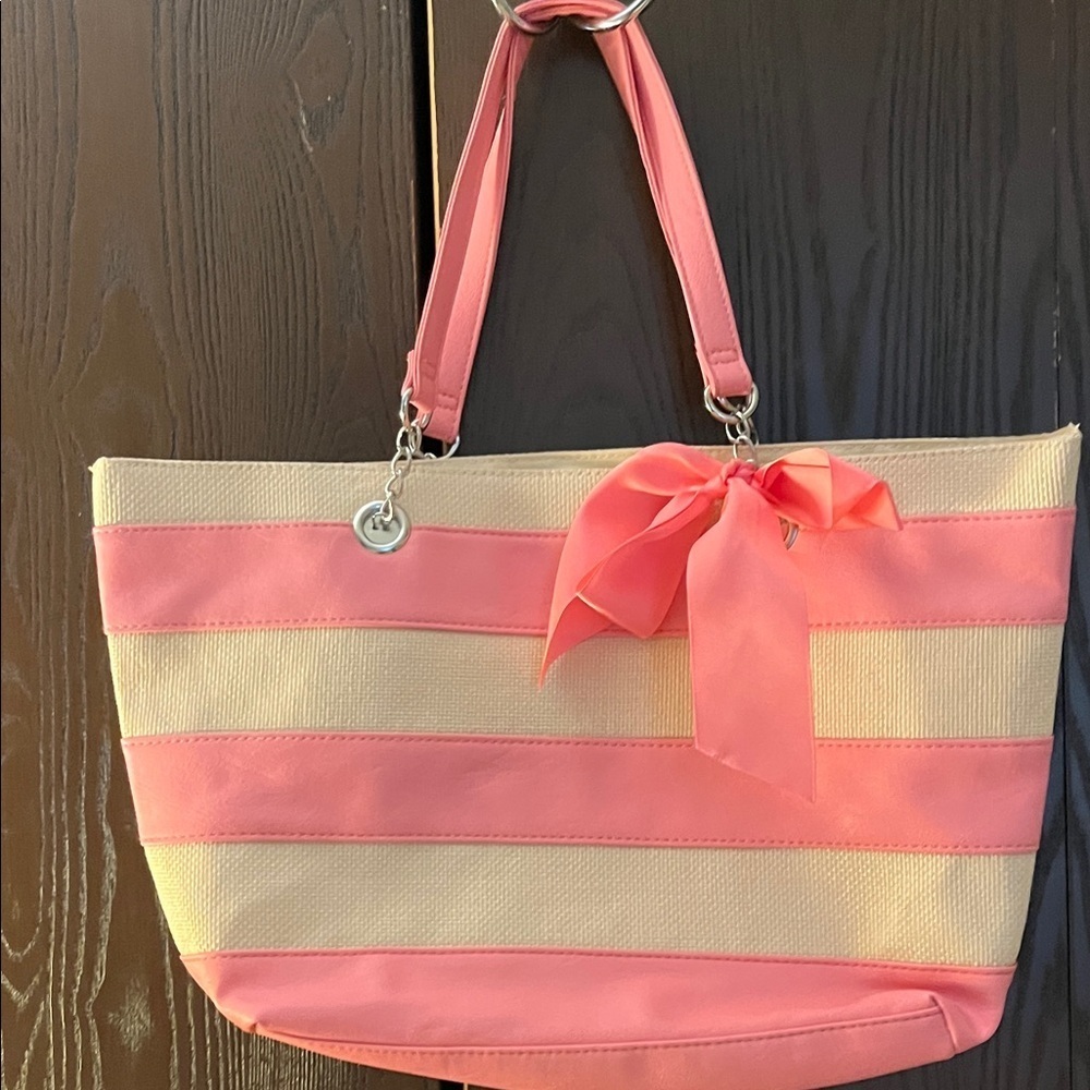 No brand pink and tan bag with a pink strap and bow.